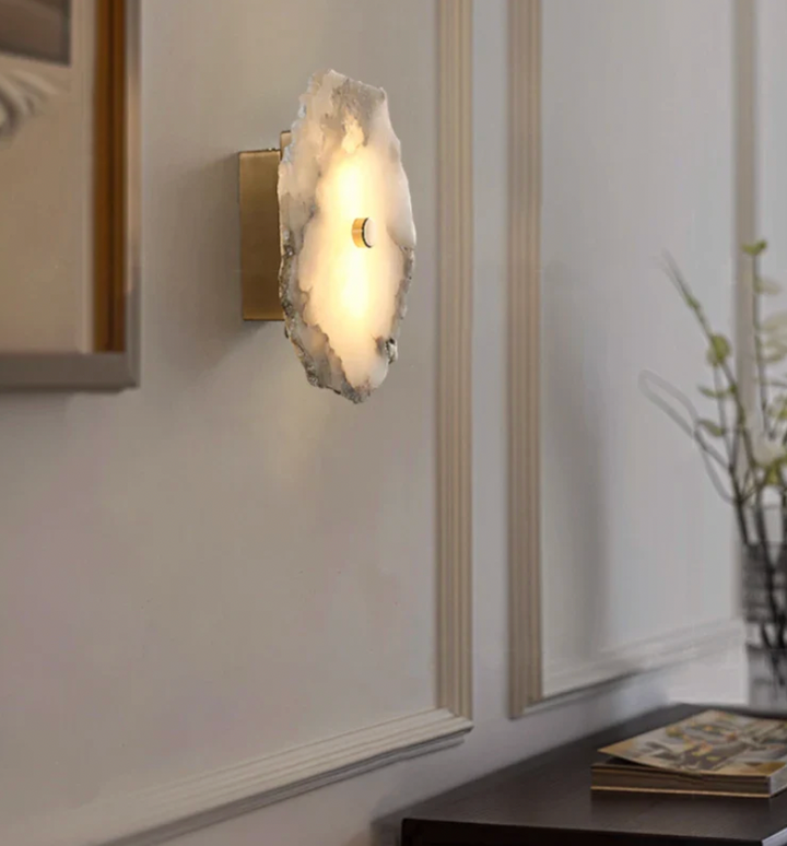 Warm glowing LED wall sconce casting beautiful patterns through alabaster panels
