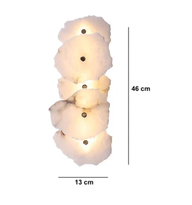 Designer wall light sconce turned on, emphasizing natural variations in alabaster