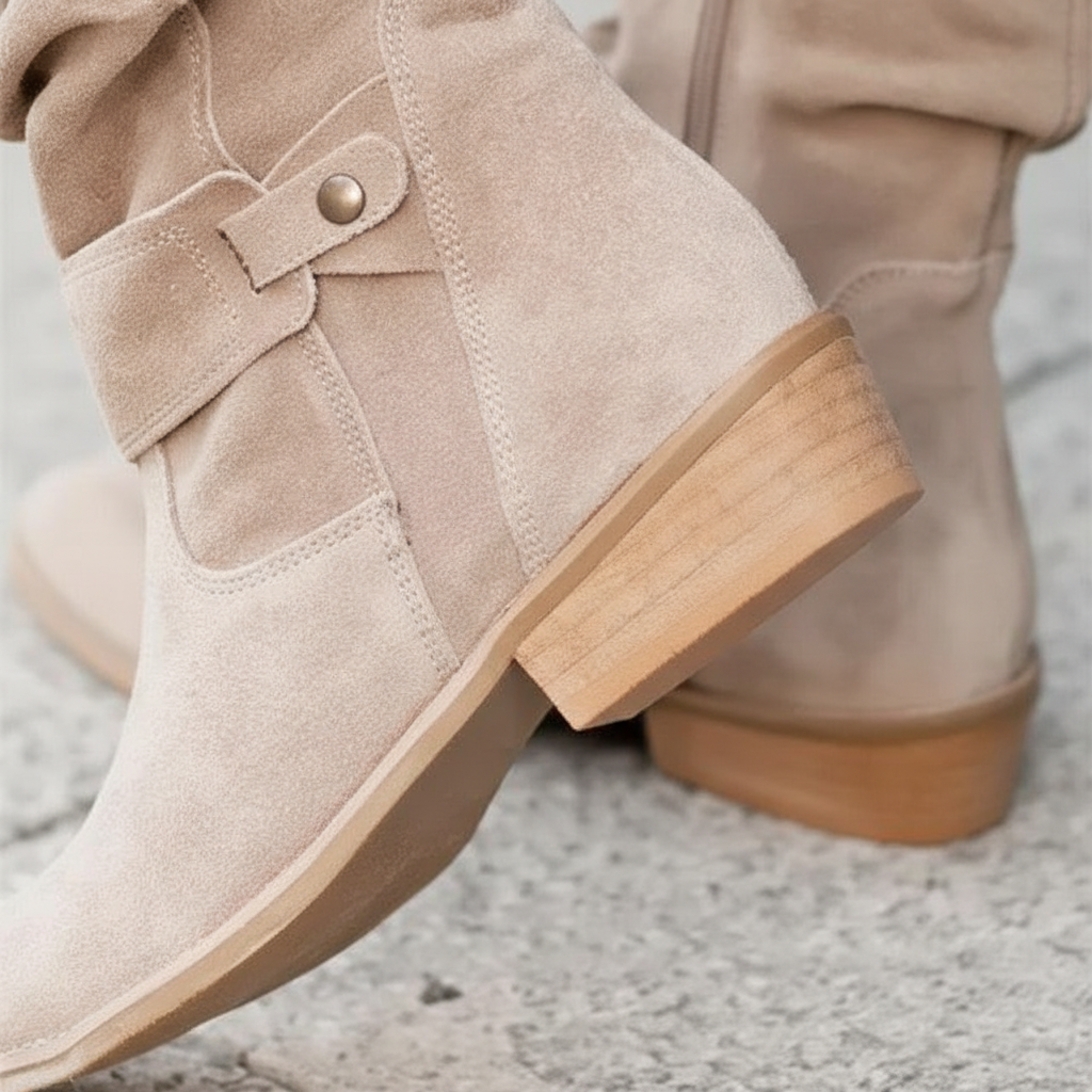 Close-up shot highlighting the low wooden block heel and flexible sole of the comfortable women's ankle boots