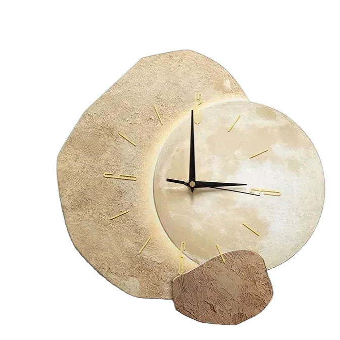 Modern light brown asymmetric wall clock with moon dial design mounted on a white wall