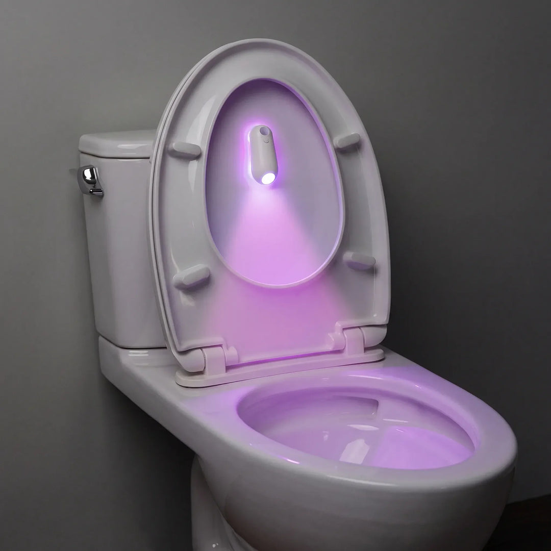 Motion activated toilet light illuminating toilet bowl in purple