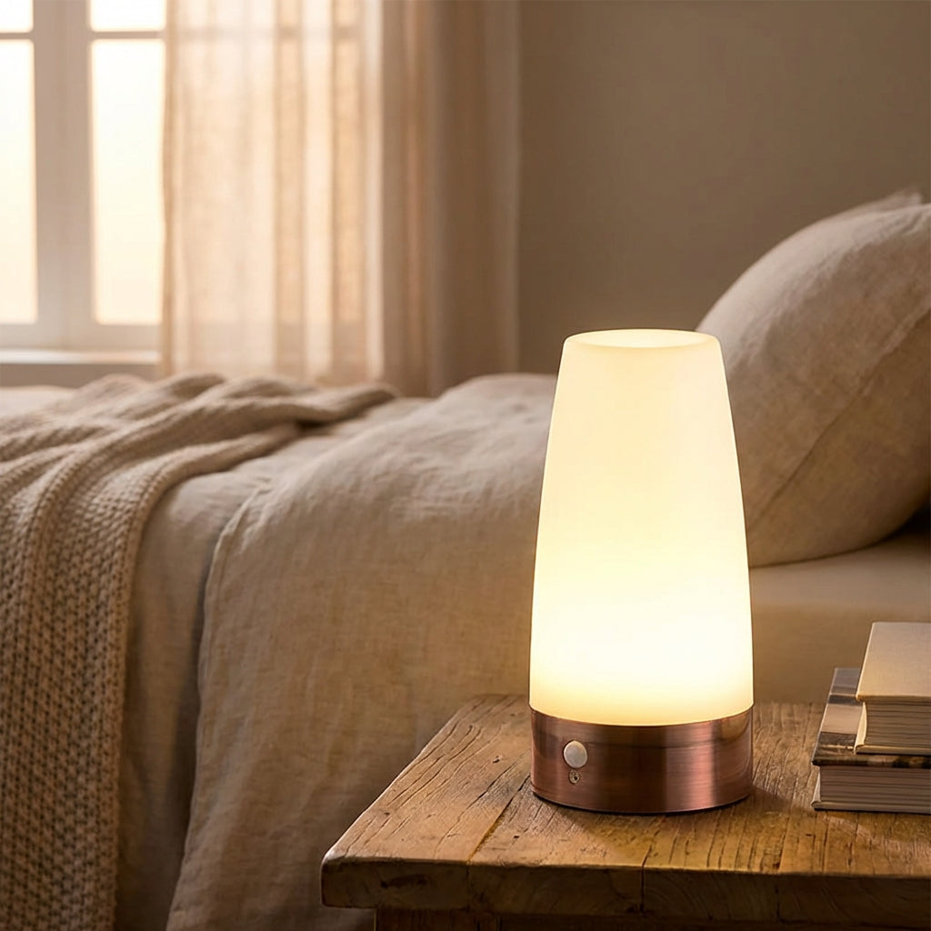 Motion sensor night light placed on a wooden bedside table in a cozy bedroom