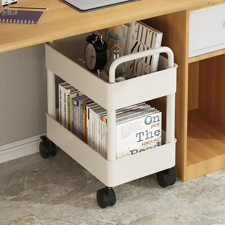 White mobile bookshelf trolley loaded with books and accessories under a desk