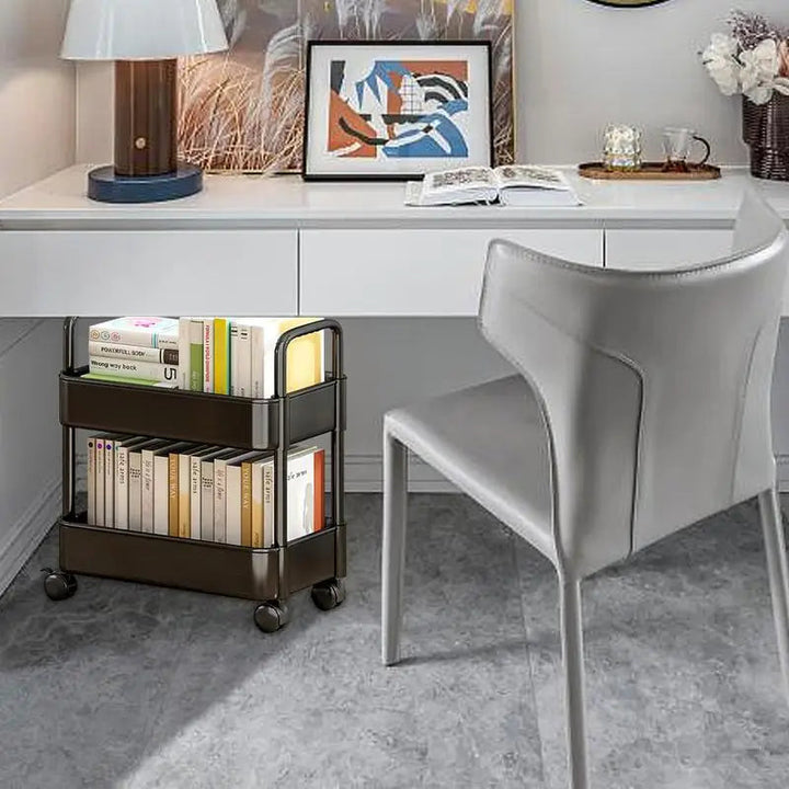 Compact rolling storage cart and book organizer beside a desk for easy access