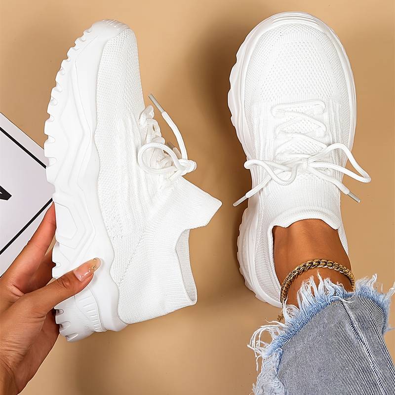 White women's orthopedic walking sneakers shown from top and side angle