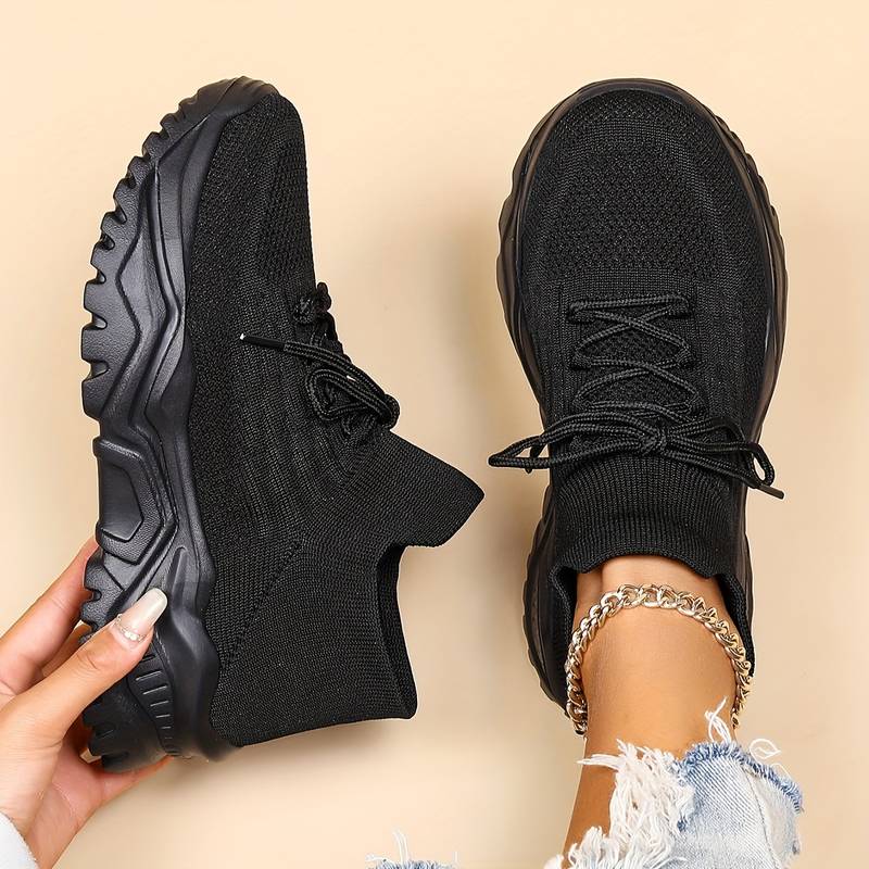 Black women's orthopedic walking sneakers displayed on neutral background