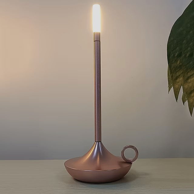 Close-up of the sleek metallic finish and LED bulb of the cordless table lamp