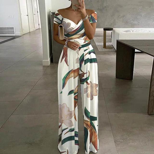 Woman wearing tropical botanical print off-shoulder jumpsuit