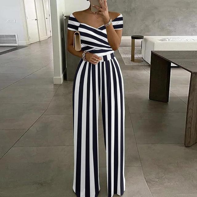 Woman wearing navy blue and white striped off-shoulder jumpsuit