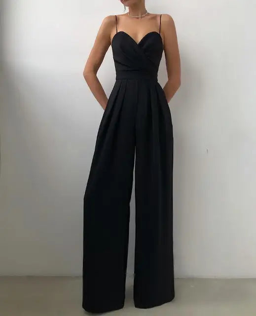 Model posing in a classic black wide leg jumpsuit
