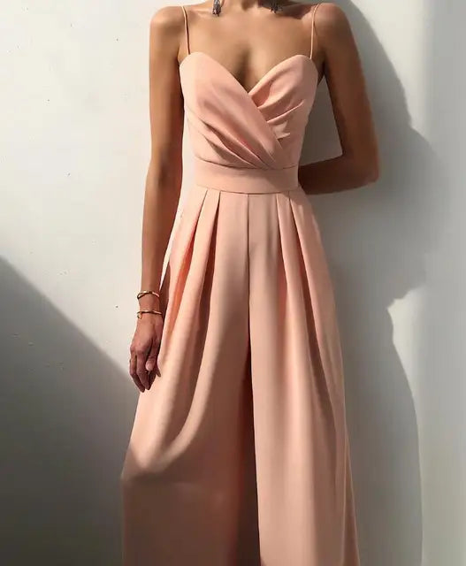 Model walking in stylish summer fashion jumpsuit with comfortable wide legs