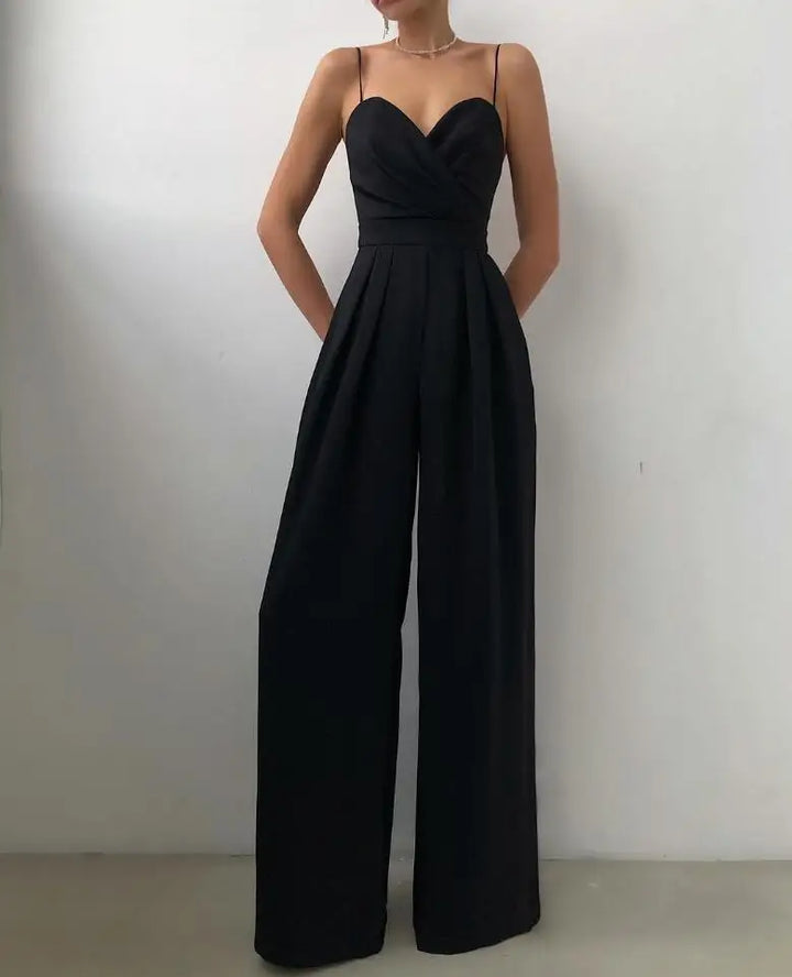 Lifestyle shot of woman in trendy wide leg jumpsuit during summer evening