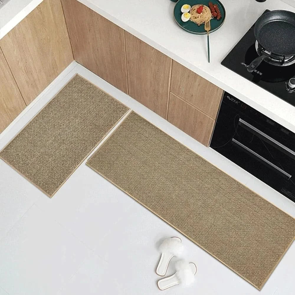 Overhead view of khaki kitchen runner and matching mat arranged near kitchen cabinets and stove