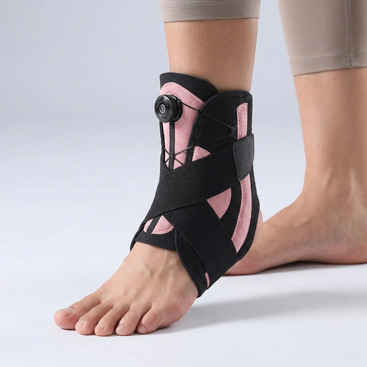 Close-up of the Black Pink adjustable ankle support brace worn on a foot