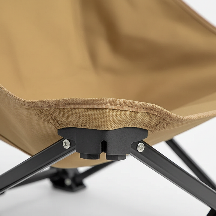 Low profile folding camping chair set up on grass for outdoor relaxation