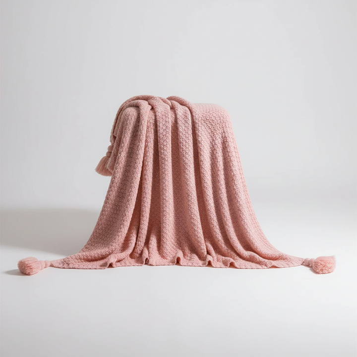 Chunky knit throw blanket with decorative tassels for cozy living room decor