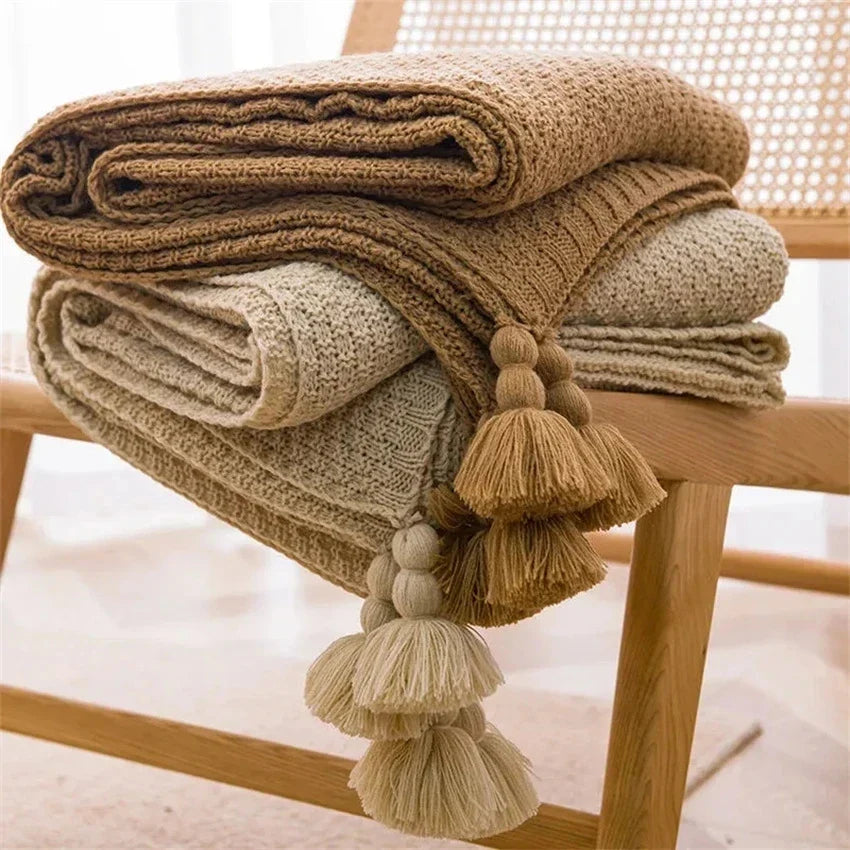 Decorative throw blanket with playful tassels adding texture to interior design
