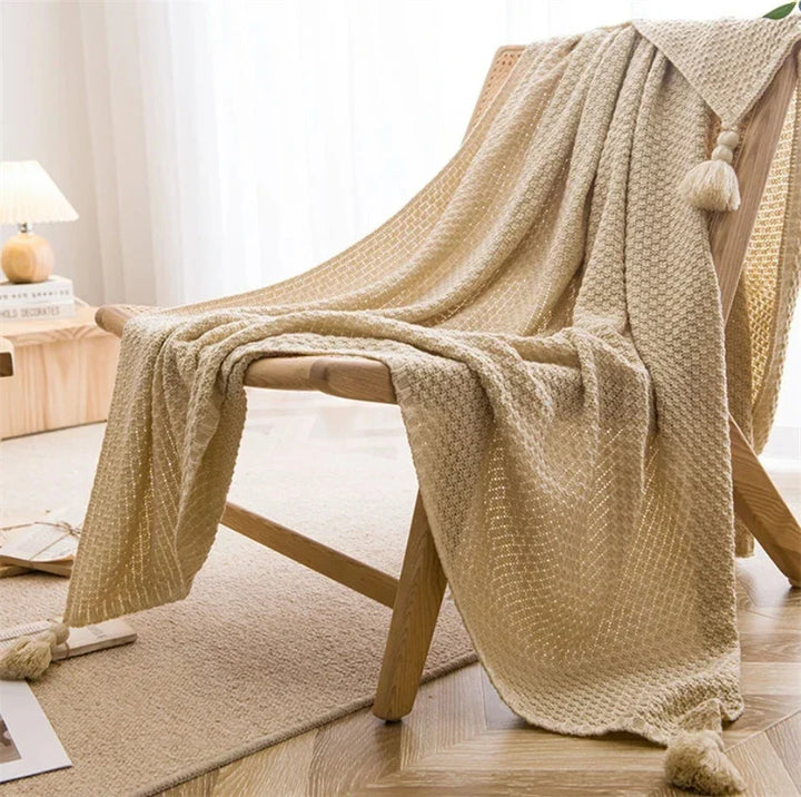 Relaxing home setting featuring a cozy knit blanket on an armchair