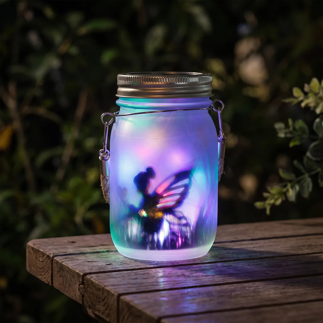 Frosted solar fairy lantern glowing on a wooden garden table