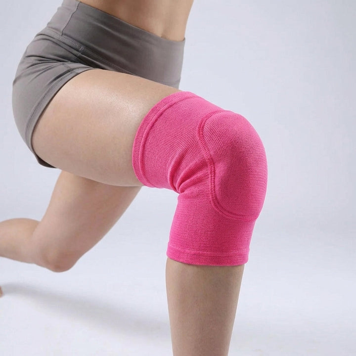 Person wearing a pink compression knee sleeve during athletic training