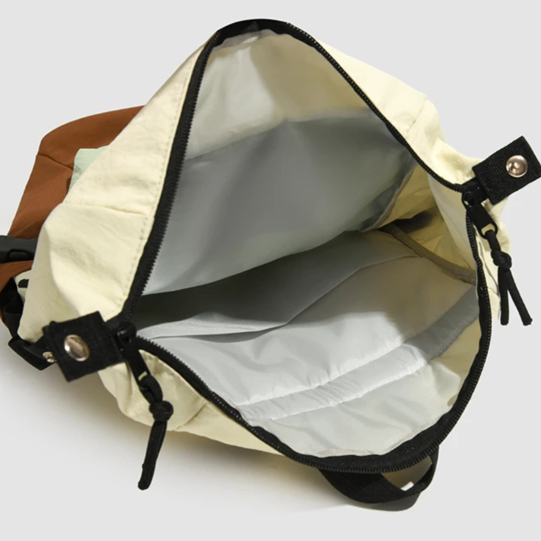 Water-resistant backpack shown protected by its bright high-visibility rain cover