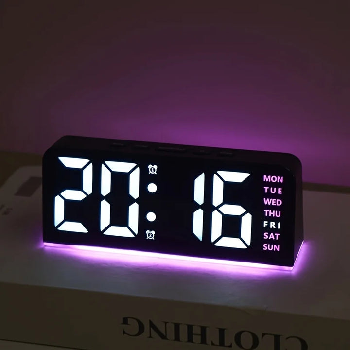 Compact LED bedside clock angled to show the control buttons on top