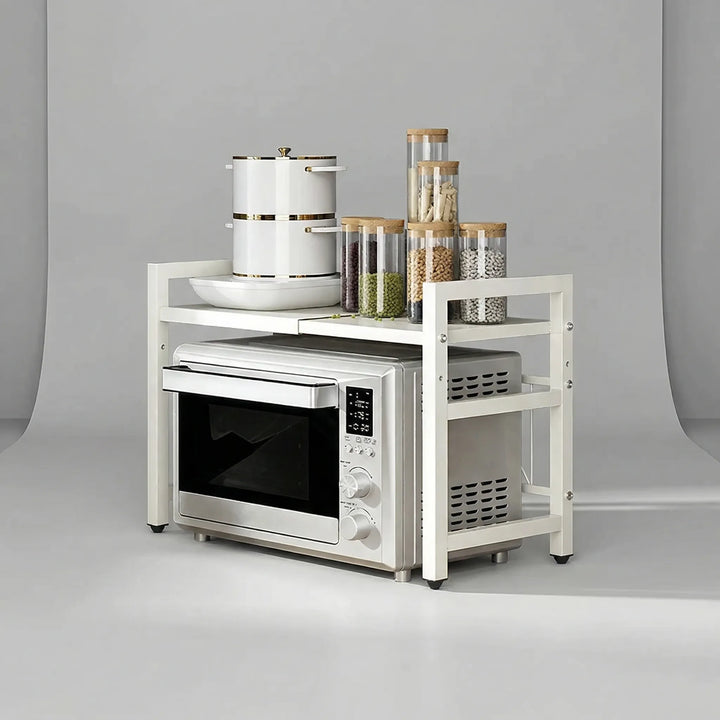 White Microlane expandable microwave shelf holding kitchen jars and a pot over a microwave on a neutral background