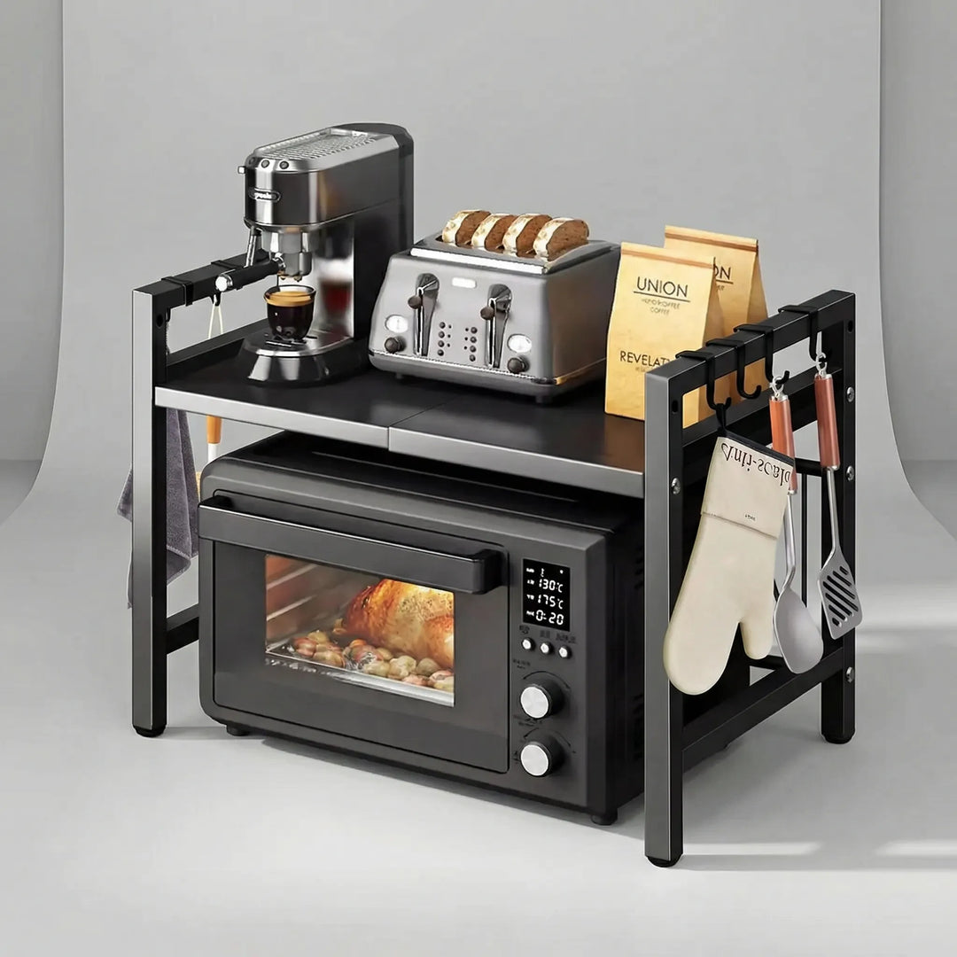 Black Microlane expandable microwave shelf holding a coffee maker and toaster with utensils hanging on the side hooks