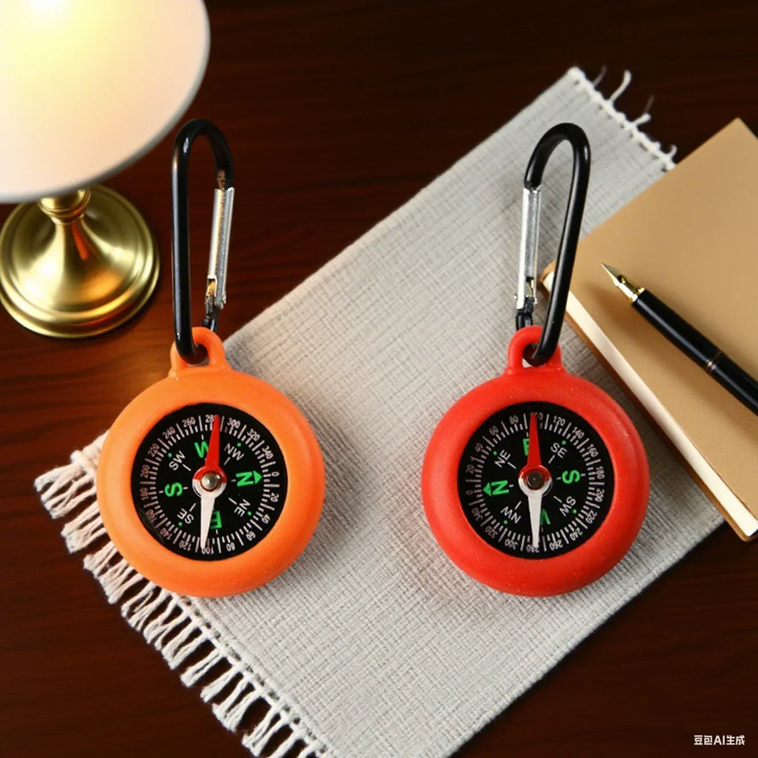 Small tactical compass attached to metal loop for quick survival use