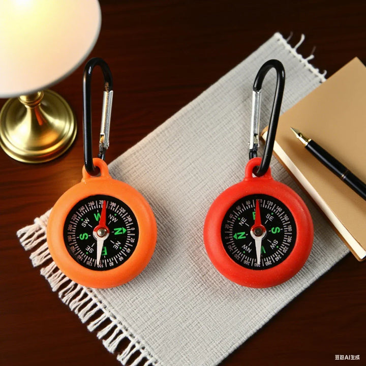 Small tactical compass attached to metal loop for quick survival use