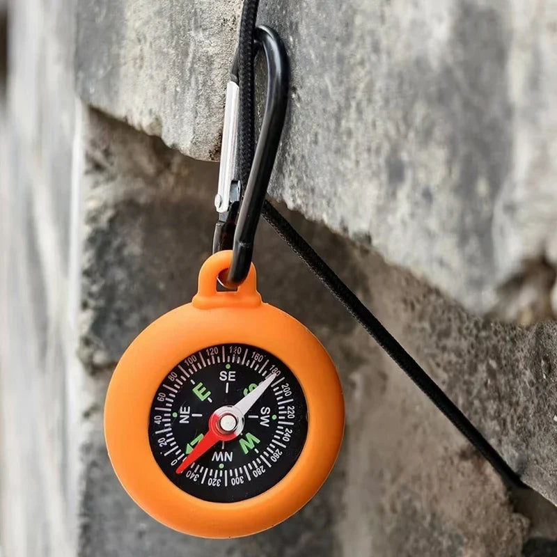 Compact survival gear compass viewed from top angle for clear reading