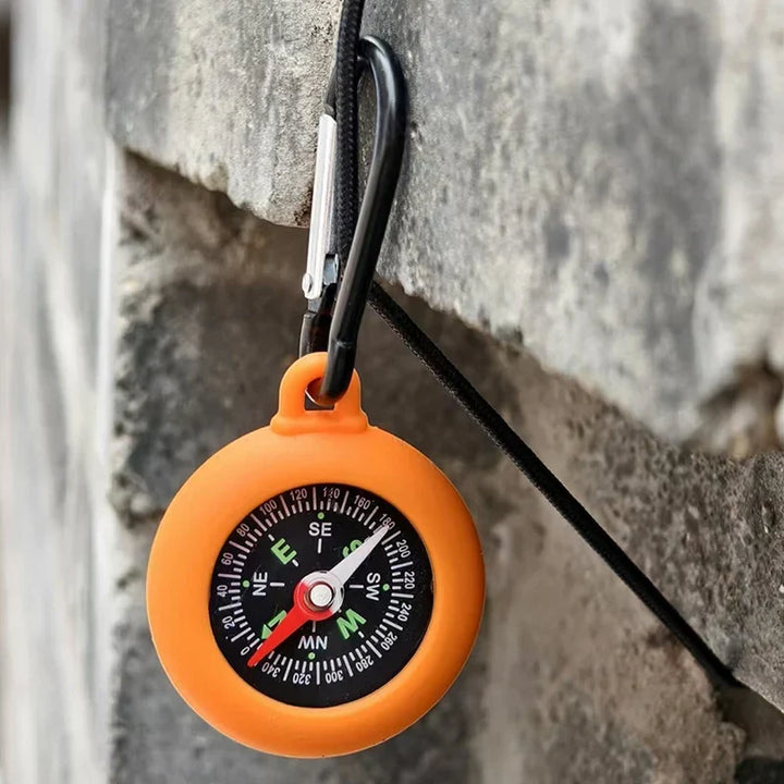 Compact survival gear compass viewed from top angle for clear reading