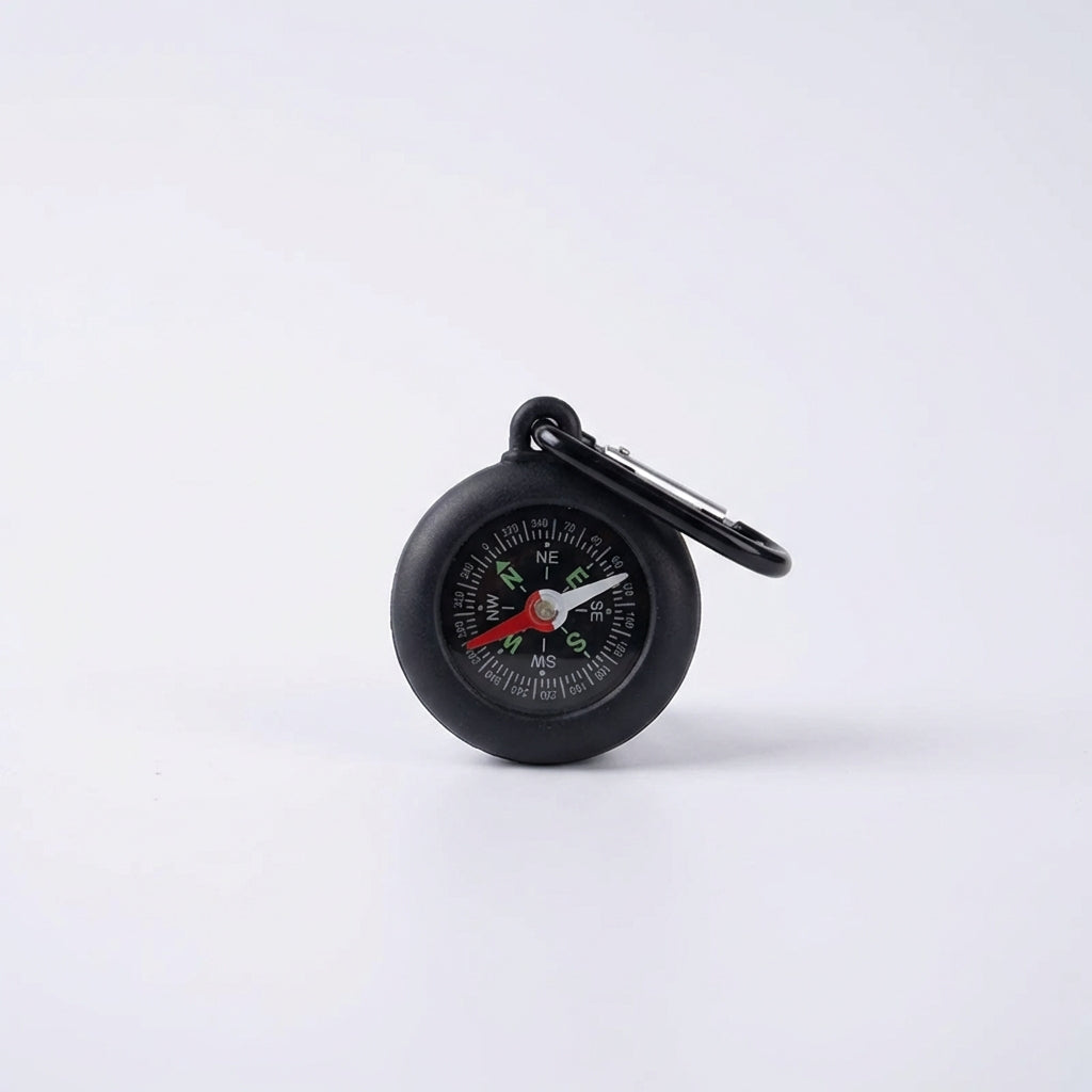 Close-up of portable navigation compass dial showing precise cardinal points