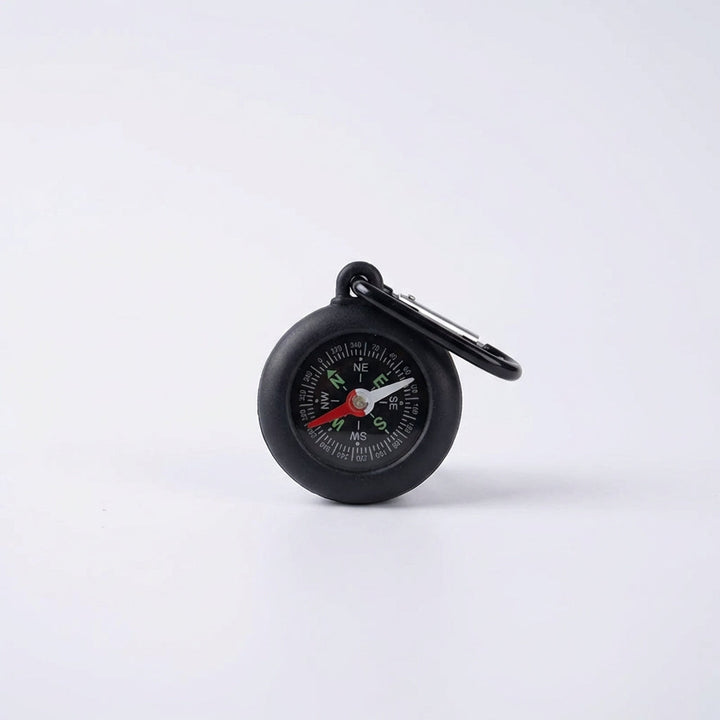 Close-up of portable navigation compass dial showing precise cardinal points