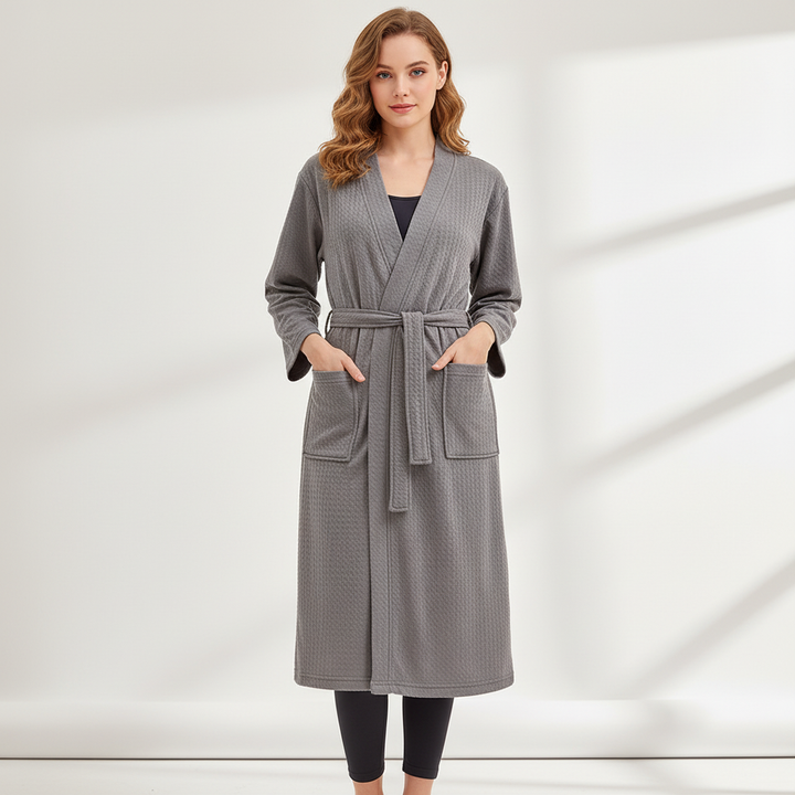 Detailed view of deep front pockets and secure tie belt on unisex bathrobe