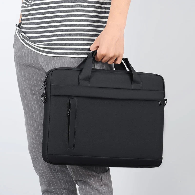Side profile of slim black computer bag showing ergonomic travel design.