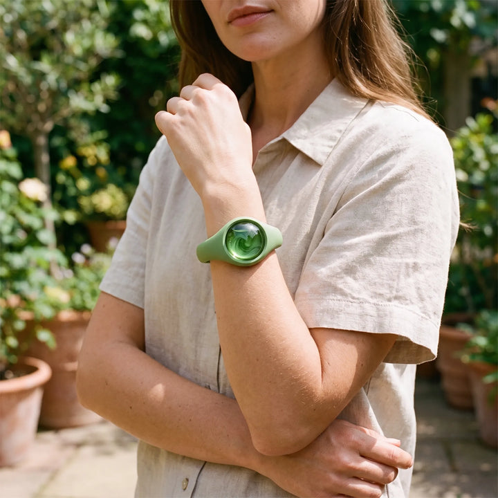 Woman wearing a green essential oil scent wristband outdoors