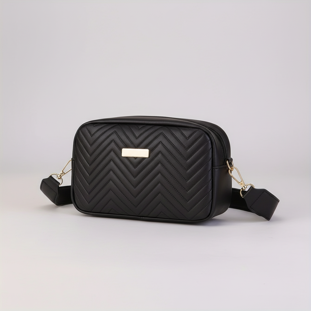 Close-up view of the quilted texture and metallic clasp on the white mini bag