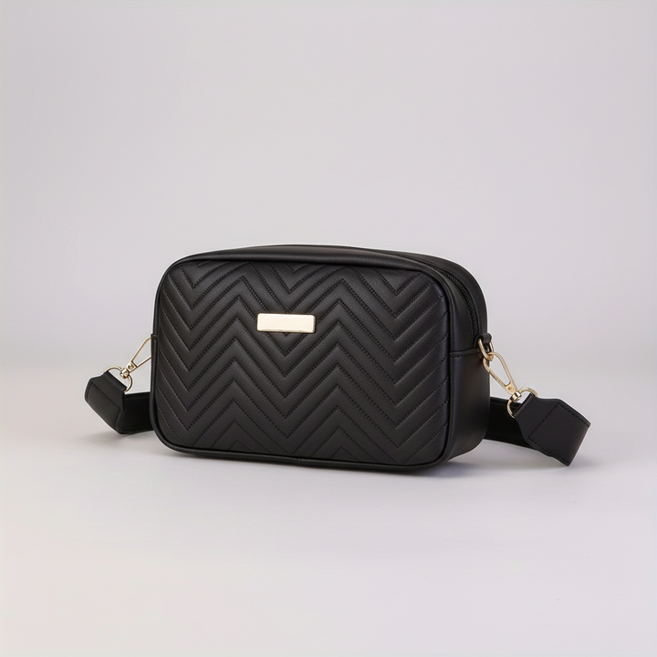 Close-up view of the quilted texture and metallic clasp on the white mini bag