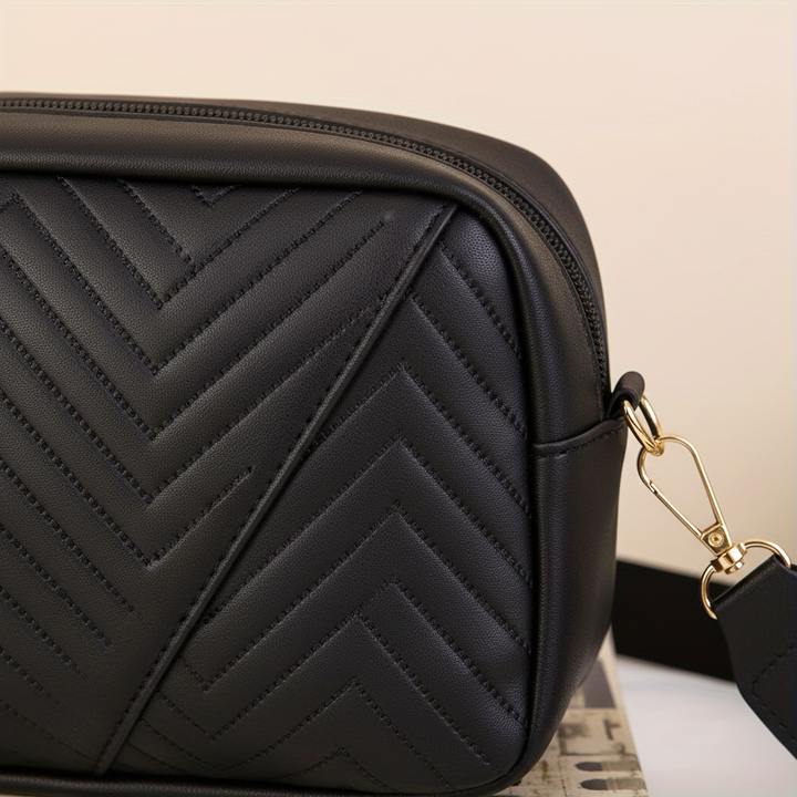 Quilted mini crossbody bag worn as a stylish shoulder bag in black
