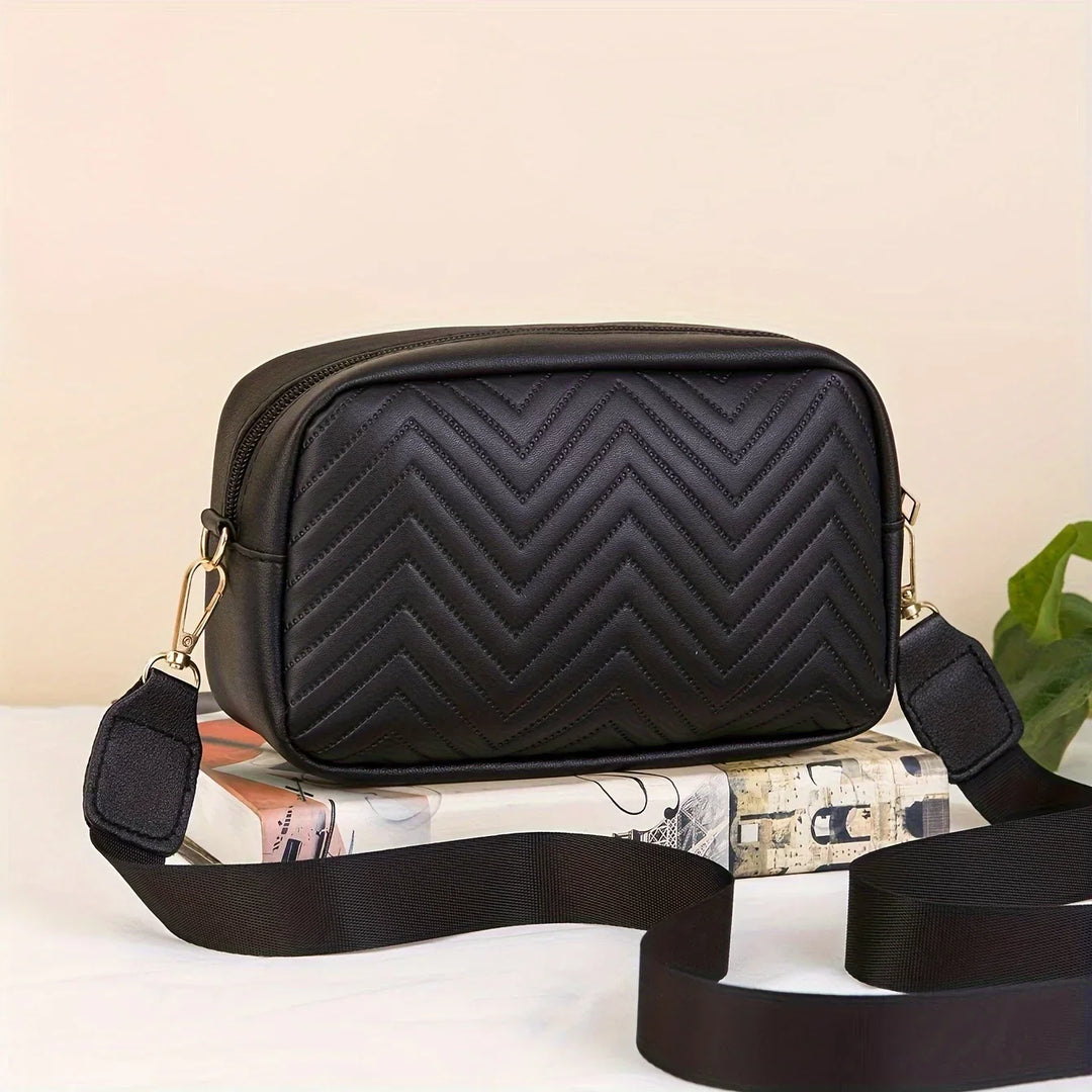 Womens everyday black quilted handbag shown from the side profile