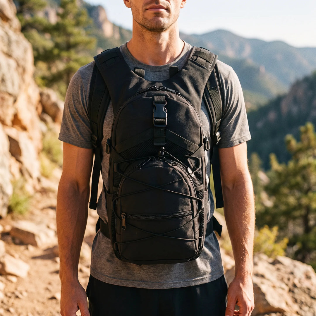 Man wearing a black compact tactical hiking rucksack on a mountain trail