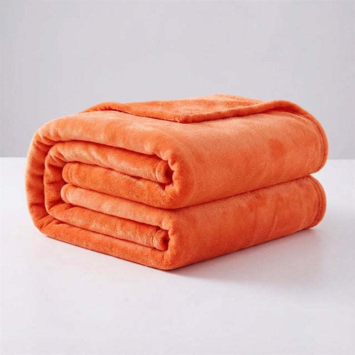Snugluma lightweight throw blanket folded in a neat stack for storage