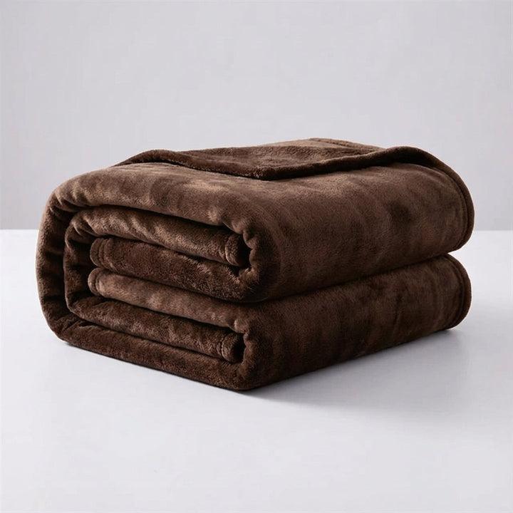 Person relaxing wrapped in a Snugluma soft blanket for ultimate comfort