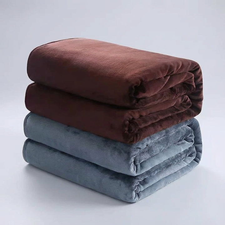 Warm and cozy Snugluma bed throw styled in a minimalist bedroom