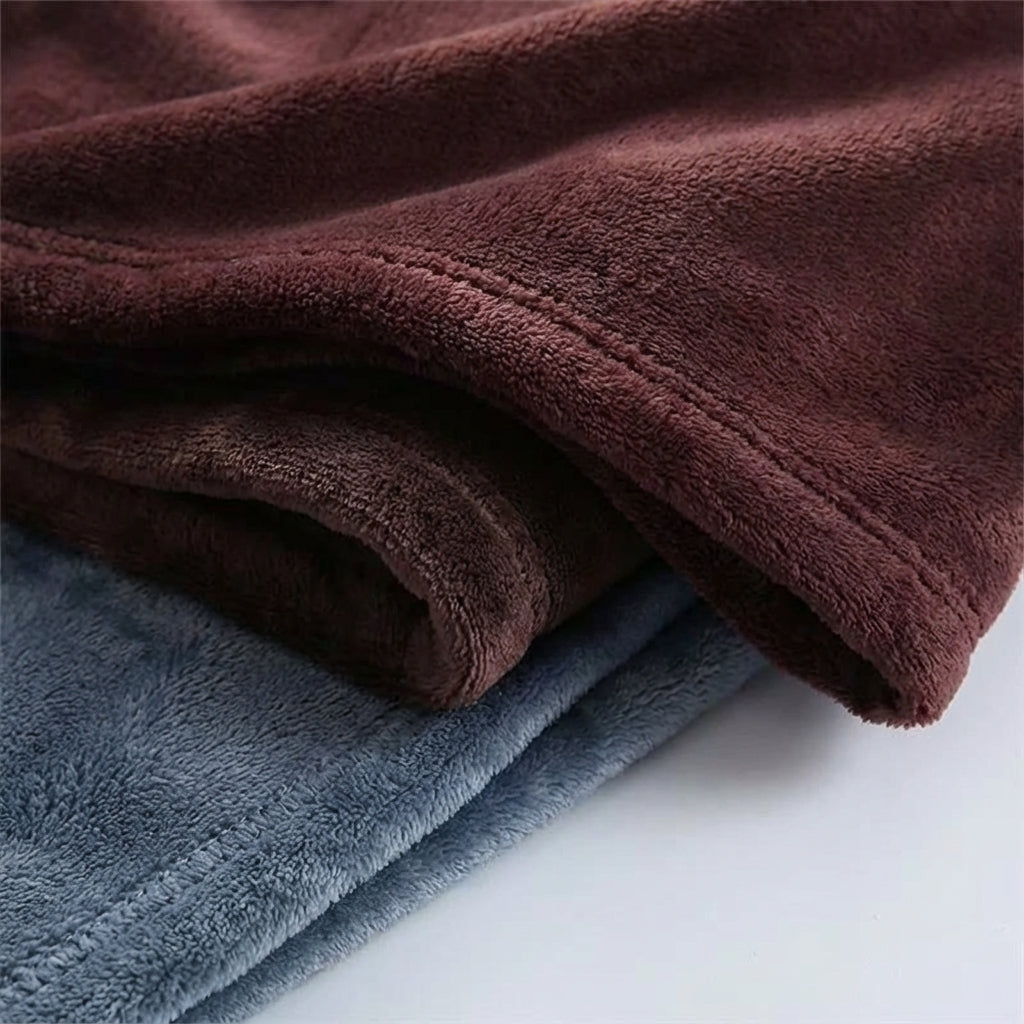 Snugluma home textiles throw blanket draped over a wooden bench