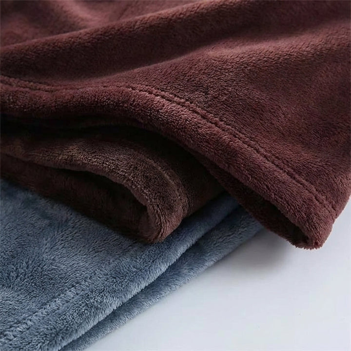Snugluma home textiles throw blanket draped over a wooden bench