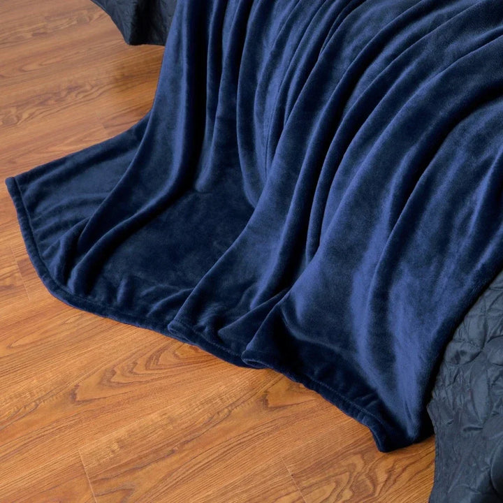 Snugluma cozy decor throw blanket folded across the foot of a bed