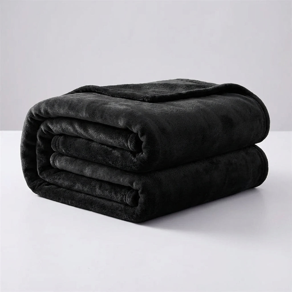 A neatly folded black plush throw blanket displayed against a clean light background.