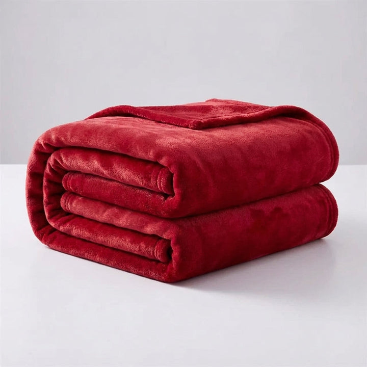 Snugluma lightweight bed throw blanket folded neatly, showing soft plush texture
